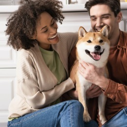a couple laughs with their dog