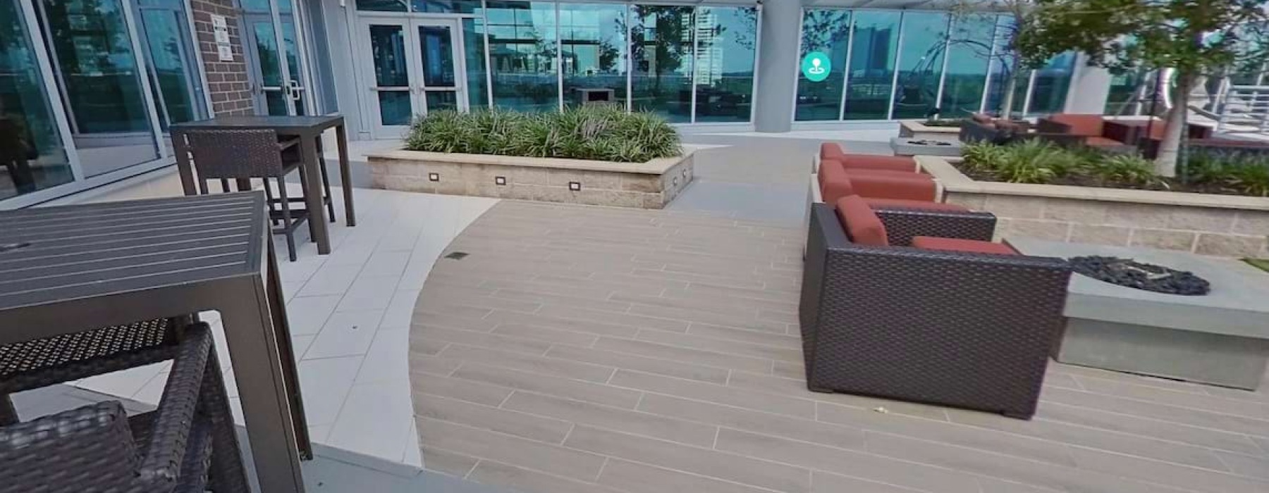 a patio with lounge chairs and tables