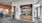a room with a brick wall and a wood cabinet with a sign on it