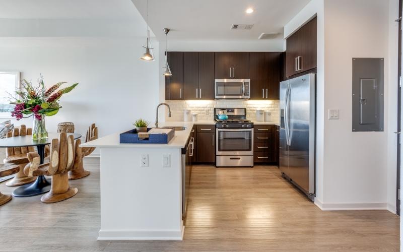 a kitchen with a table and a refrigerator